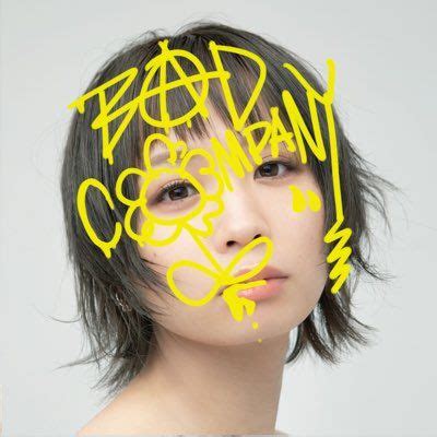 a woman with yellow spray paint on her face and the words pacman coming out of her head