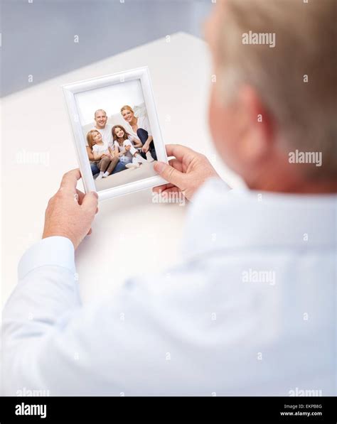 close up of old man holding happy family photo Stock Photo - Alamy