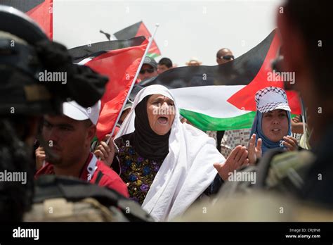 Palestinian women confront Israeli soldiers in a demonstration near ...