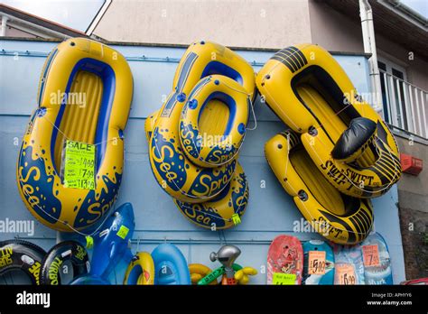 Inflatable dinghies on display outside a shop in Pembrokeshire Stock Photo - Alamy