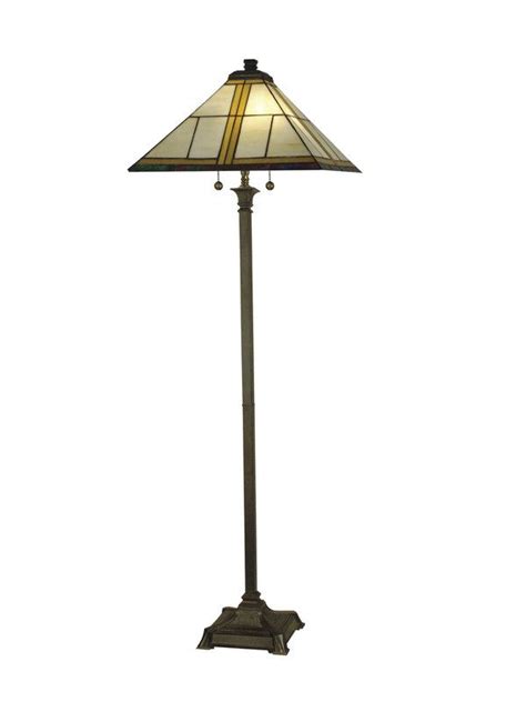 a lamp that is sitting on top of a table with a glass shade over it