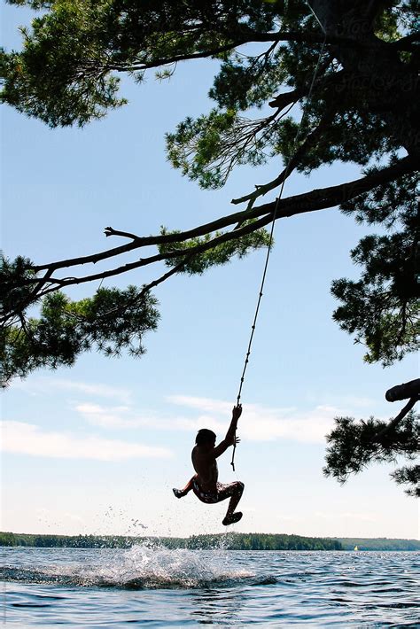 "Child On Rope Swing At Lake In Maine" by Stocksy Contributor "Raymond ...