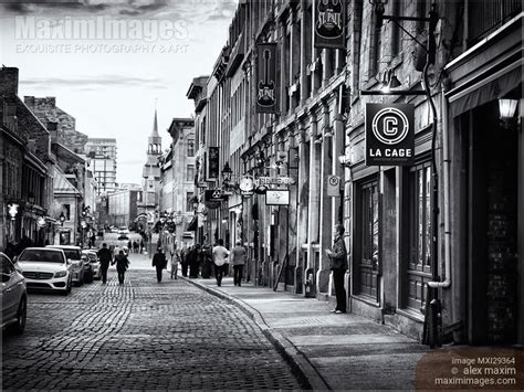 Photo of People walking on Rue Saint Paul historic street of old town ...