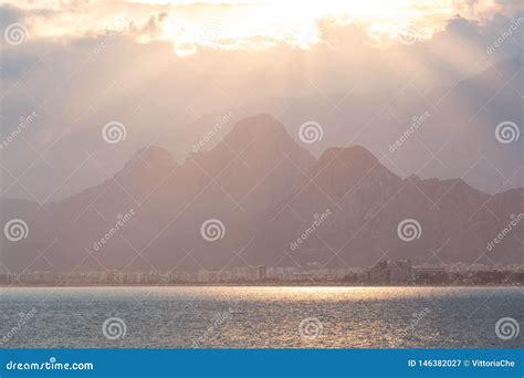 Scenic View of Famous Turkish Konyaalti Beach on the Sunset. the Sunbeams Break through the ...