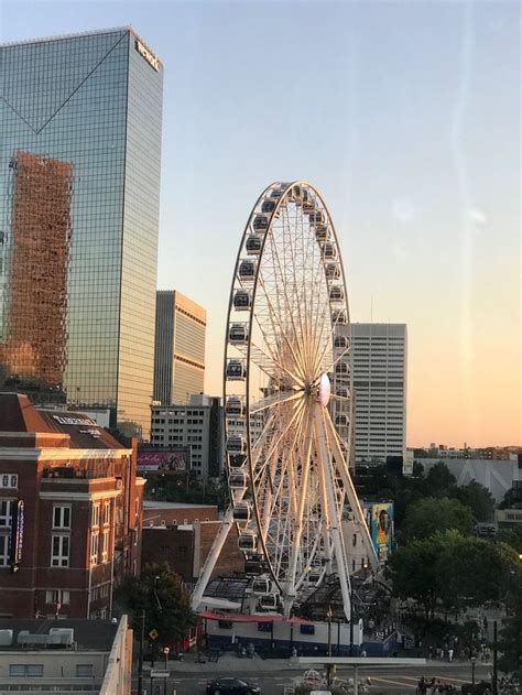 a large ferris wheel sitting in the middle of a city