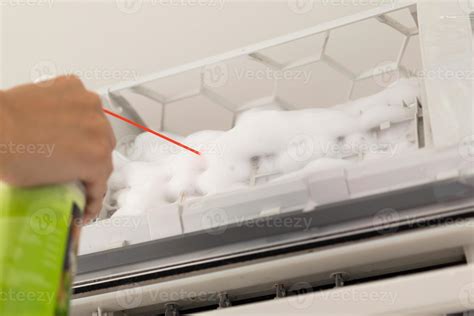 air conditioner cleaning with spray foam cleaner 13008544 Stock Photo at Vecteezy