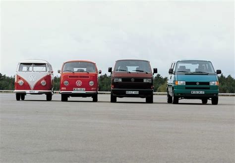 three vw buses are lined up in a row