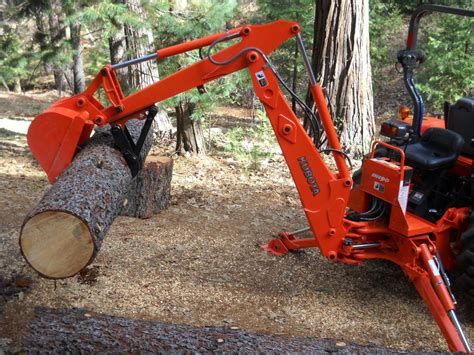 MT618 mini excavator thumb on a Kubota BH90 backhoe log lifting 1