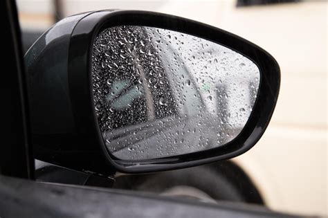 Premium Photo | Rain drops on car side mirror