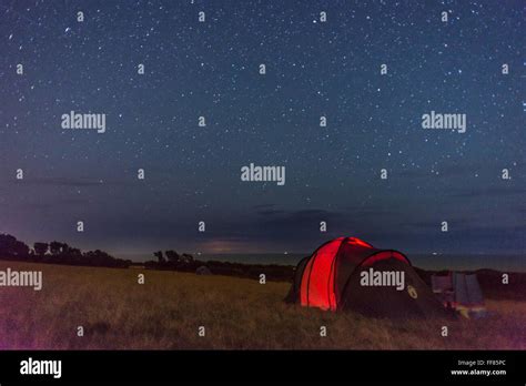 Camping underneath the stars on a clear night in the South Hams of Devon Stock Photo - Alamy