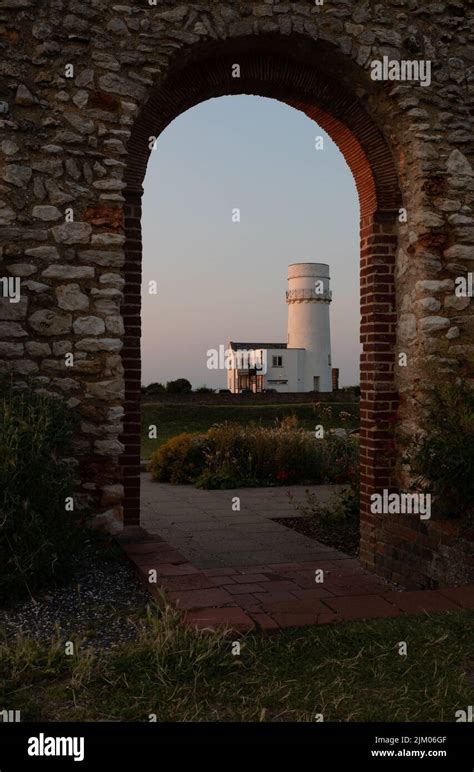 The lighthouse in Old Hunstanton at sunset through the archway of an old abbey Stock Photo - Alamy