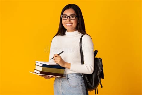 Asian Student Girl Holding Books Standing Over Yellow Background ...