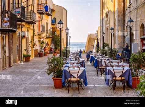 Old town square with a trattoria in Cefalù, Sicily. Cefalu is a major Stock Photo - Alamy