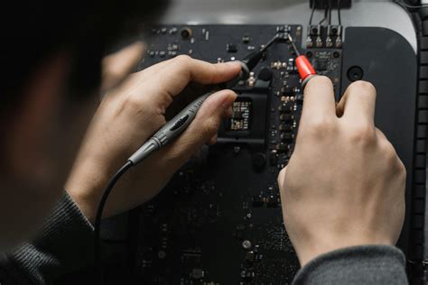 Person Using a Soldering Iron on a Circuit Board · Free Stock Photo