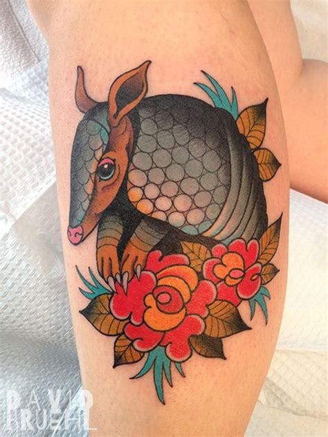 Traditional tattoo of an armadillo and folk art roses on a leg. By ...