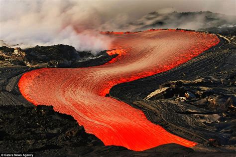 Daredevil photographers brave boiling waters to capture the drama of searing-hot lava crashing ...