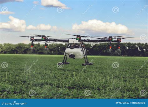 Professional Large Drone Spray Water Over a Green Field. Stock Image - Image of people ...