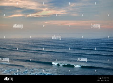 Sunrise and clouds with waves. Cannon Beach. Oregon Stock Photo - Alamy