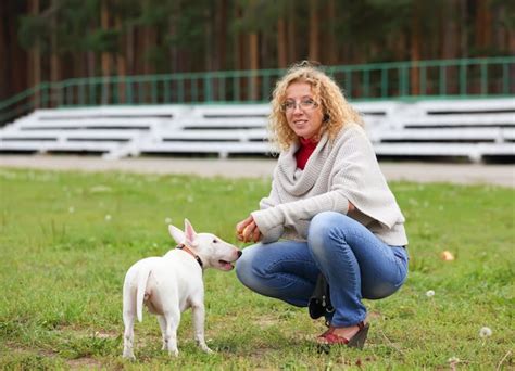 Premium Photo | Young girl walking and training her bucovina shepherd ...