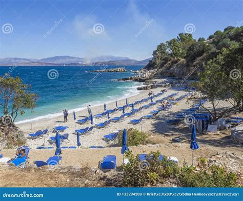 Greece, Corfu, Kassiopi September 28, 2018: View of Bataria White Sand Beach with Blue Sunbeds ...