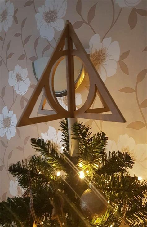 a harry potter christmas tree topper with lights in the shape of a deathly hall