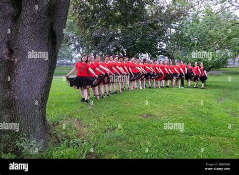 Posed group photo of a dance group comprised of middle aged Chinese American women. In Queens ...