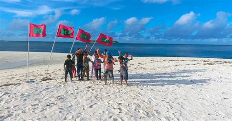 Local People Standing In Front Of Maldives Flag Planted In The Beach ...