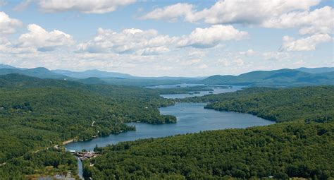 A beautiful aerial photo of Squam Lake, New Hampshire with Riveredge Marina in the foreground ...