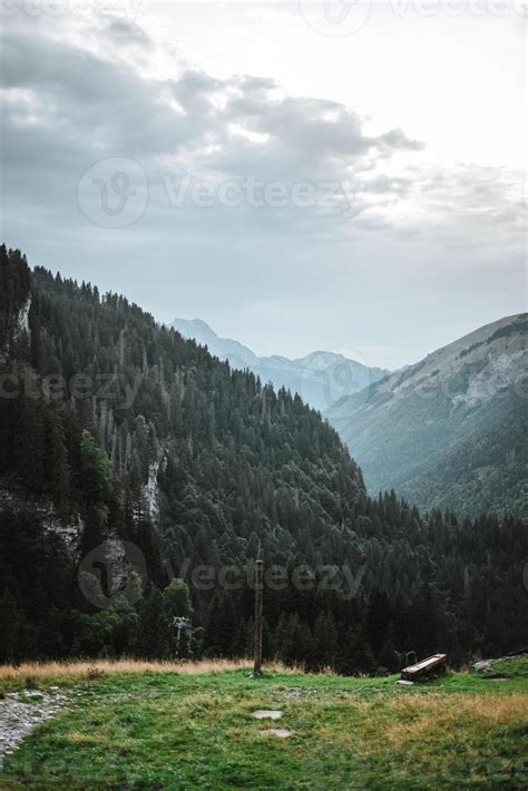 Majestic mountains in the Alps covered with trees and clouds 20498378 Stock Photo at Vecteezy