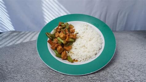 Premium Photo | A plate of stirfried rice and tempeh with fine chili ...