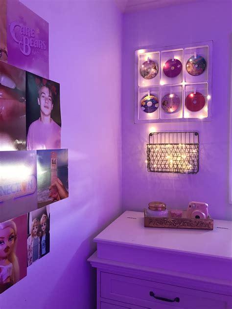 a room with purple walls and pictures on the wall