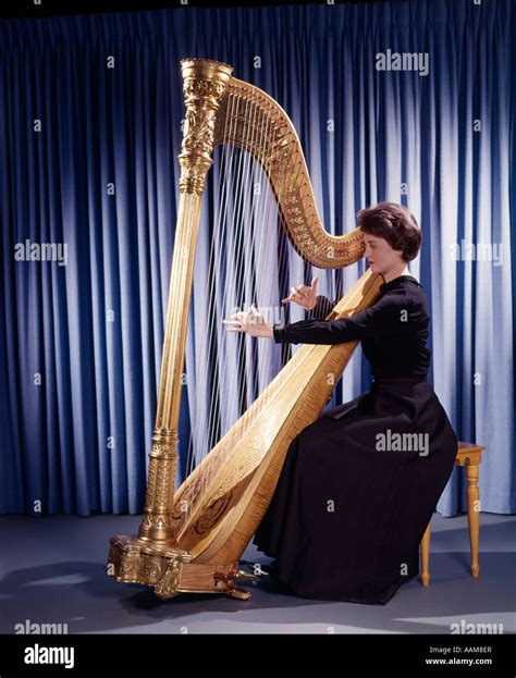 1950s 1960s 1970s RETRO WOMAN MUSICIAN PLAYING LARGE CLASSICAL HARP ...