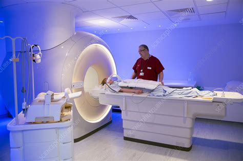 Radiographer preparing an MRI scan - Stock Image - C025/7067 - Science Photo Library