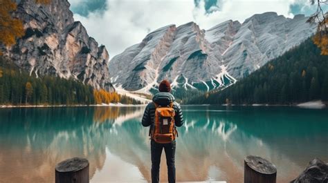 Premium AI Image | Travel hiker taking photo of Lake Braies Lago di ...