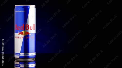 Red Bull can on dark toned background. Red Bull is an energy drink sold ...