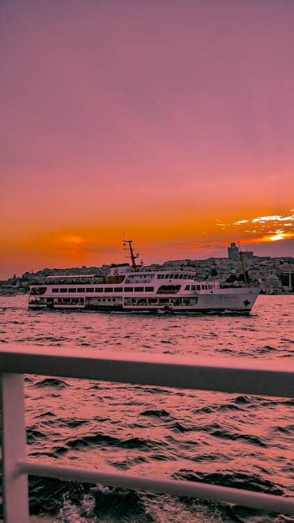 Ferry Boat on Sea During Sunset · Free Stock Photo