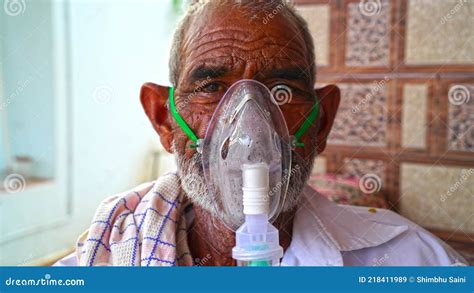 A Elder Person Infected with Covid 19 Disease. Patient Inhaling Oxygen Wearing Mask with Liquid ...