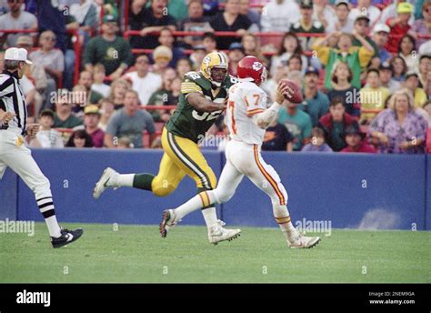 Green Bay Packers Reggie White chases down and seeks Kansas City Chiefs quarterback Dave Krieg ...