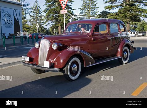 Classic vintage maroon Chevrolet motor car on road Art Deco weekend ...