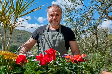 Premium Photo | Gardener is in the flower shop counter outdoors or home garden