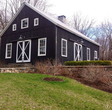 Black barn white trim with field rock fence. | Farmhouse sheds, Barn ...