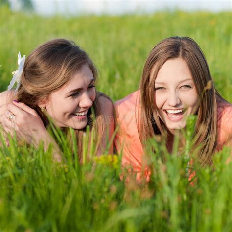 Two Young Women Friends Laughing In Green Grass Stock Photo - Image: 33551942