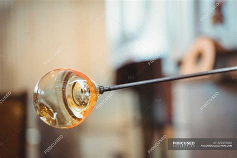 Close-up of a molten glass on blowpipe at glassblowing factory — manufacture, craft - Stock ...