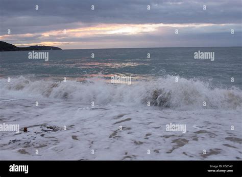 Waves crashing onto Gyllyngvase Beach, Falmouth at sunrise Stock Photo ...