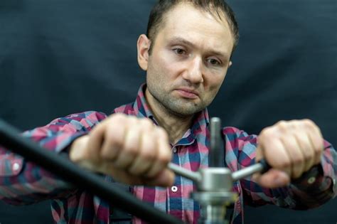 Premium Photo | Portrait of a fashionable bicycle mechanic in a workshop on a black background ...