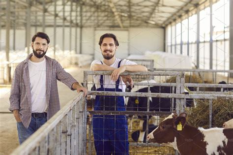 Two farm workers standing near a | Animal Stock Photos ~ Creative Market