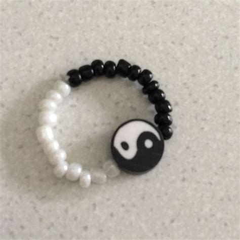 a black and white beaded bracelet with a yin symbol