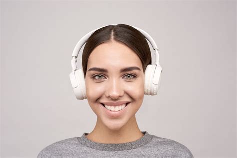 Woman Wearing Gray Crew-neck Shirt Using White Wireless Headphones Smiling · Free Stock Photo