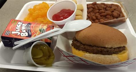 An example of a school lunch where I live: A cheeseburger, beans, smile ...