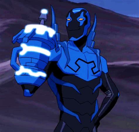 a man in blue and black suit holding a light up hand with his right arm